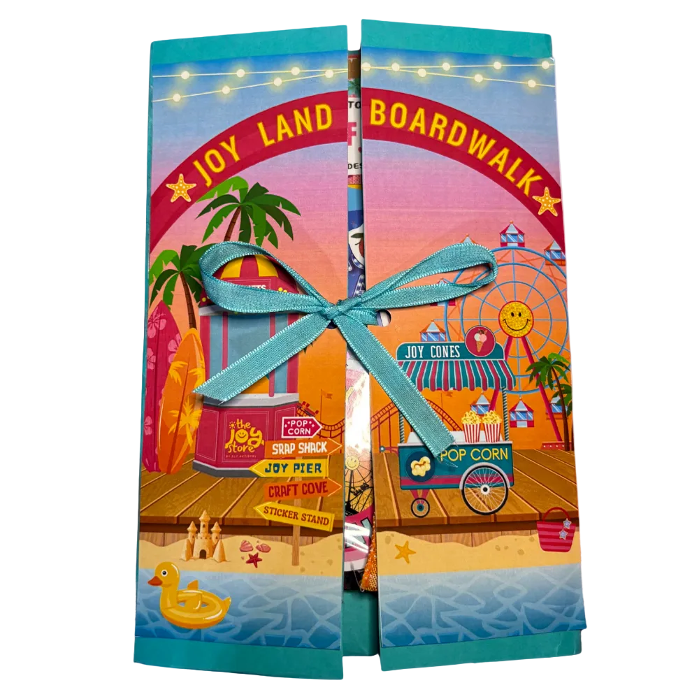 Colorful gift bag with 'Joy Land Boardwalk' design on a beach background