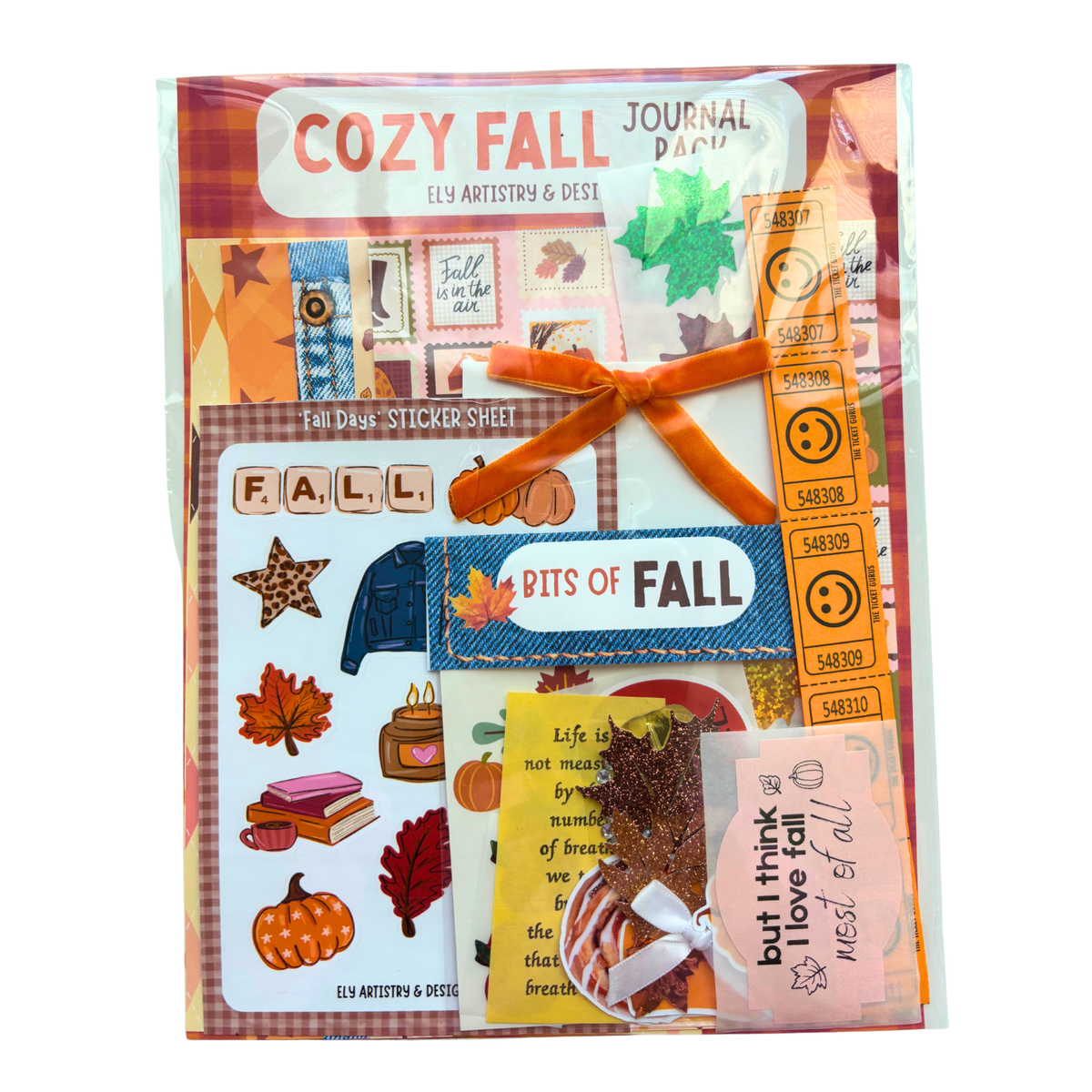 Cozy Fall Journaling Kit by Ely Artistry featuring a collection of autumn-themed paper sheets, stickers, and an orange velvet ribbon bow, all packaged in a clear plastic sleeve on a white background.